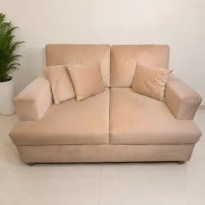 beige suede 2 seater sofa with throw pillows